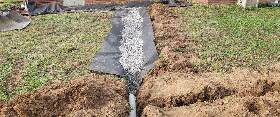 French drain being installed in a yard in Huntsville, AL.