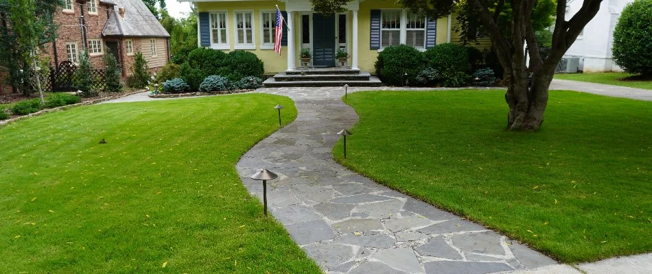 Front yard in Huntsville, AL, with a stone walkway and lawn. 