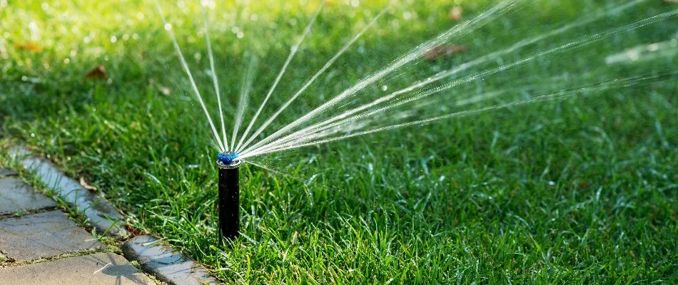 A sprinkler irrigation system watering green grass in Decherd, TN.