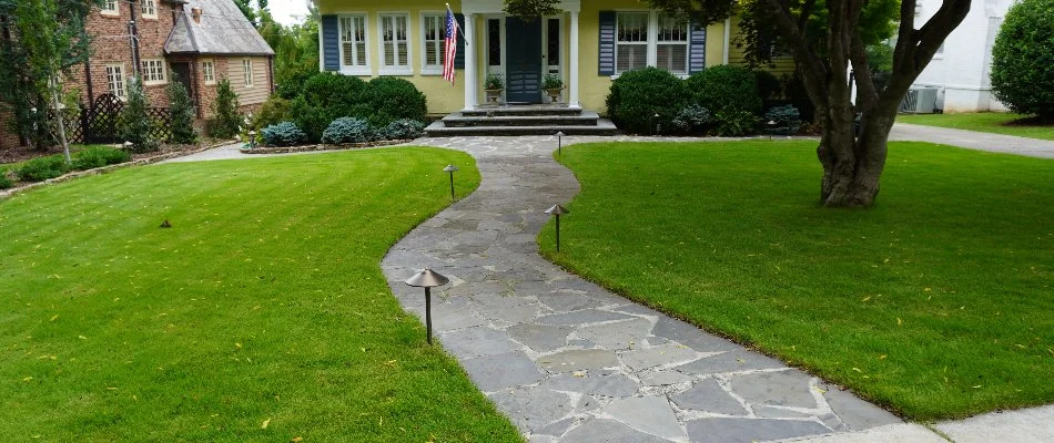 Lawn along a walkway in Triana, AL, leading to a house.