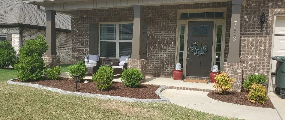 Landscape bed in Triana, AL, with small shrubs.